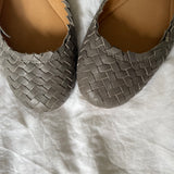 Coach woven leather ballet flats in grey with a subtle silver edge. They’re in excellent condition and show little to no signs of visible wear.